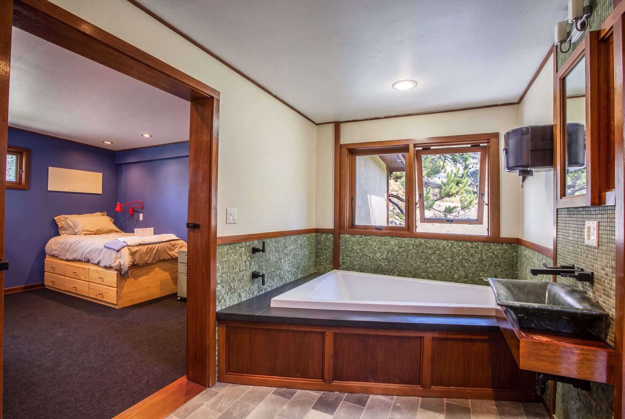 Soaking tub and mosaic tile with bedroom access