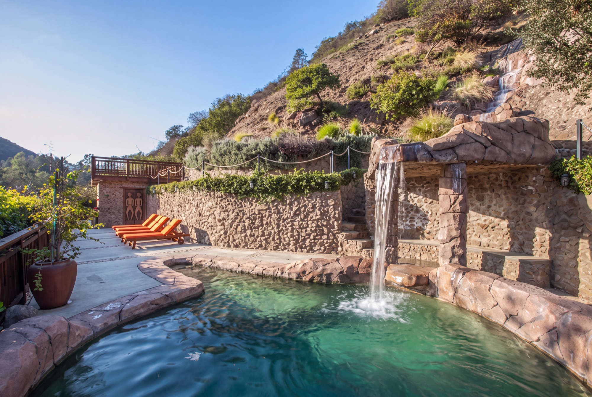 Stone grotto pool with a cascading waterfall