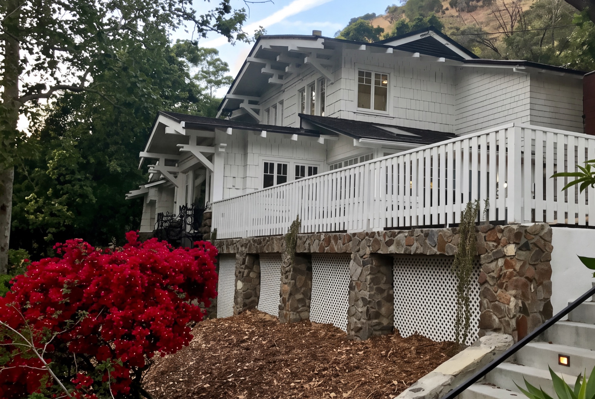 Craftsman residence surrounded by lush landscaping