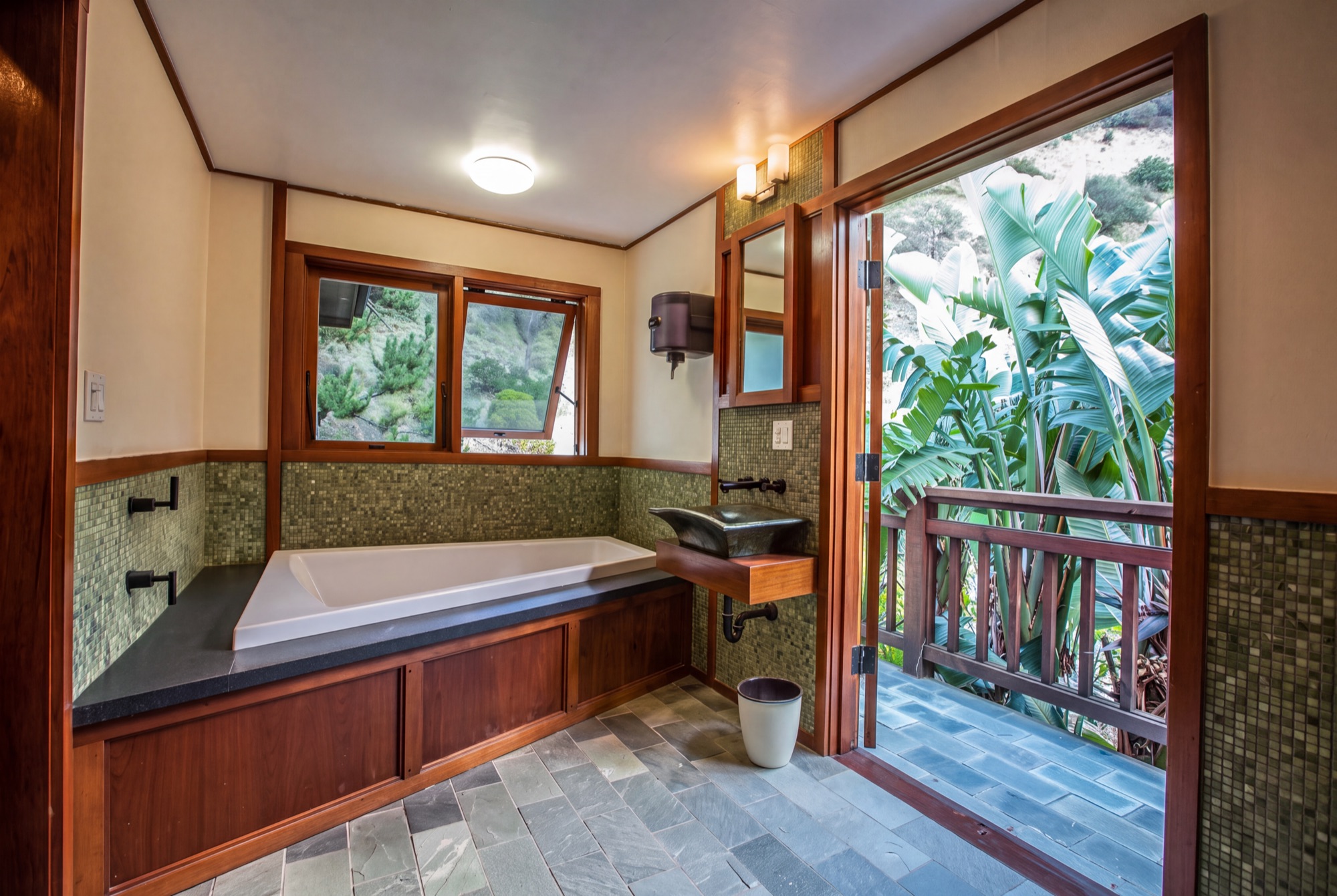 Soaking tub opening to a private canyon-view balcony